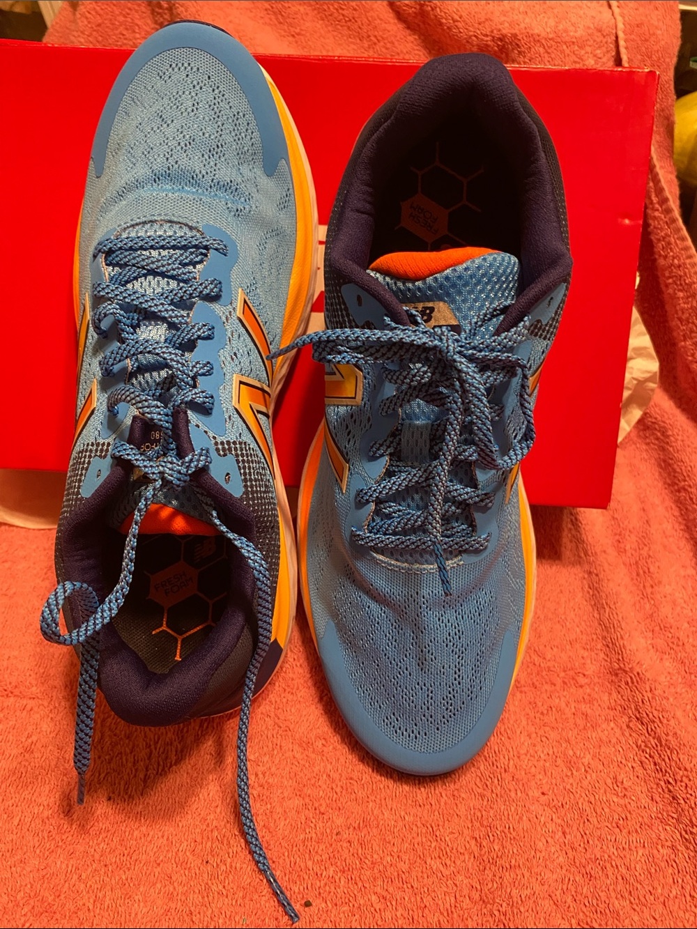 New Balance Light Blue Running Shoes with Orange Accents